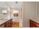 Bright bathroom boasts double sinks, wood cabinets, and a shower/tub combo at 806 E Franklin St, Chapel Hill, NC 27514
