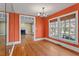 Dining room with hardwood floors, coral walls, and chandelier, view to living room at 806 E Franklin St, Chapel Hill, NC 27514