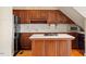 Kitchenette with wood cabinets and modern appliances at 806 E Franklin St, Chapel Hill, NC 27514