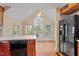 Bright kitchen with hardwood floors and sunroom access at 806 E Franklin St, Chapel Hill, NC 27514