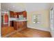 Kitchen features wood cabinets, island, and access to breakfast area at 806 E Franklin St, Chapel Hill, NC 27514