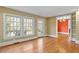 Spacious living room with hardwood floors and French doors leading to outdoor space at 806 E Franklin St, Chapel Hill, NC 27514