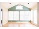 Bright sunroom with vaulted ceiling, fan, light green accent wall, and large windows at 1105 Edith St, Burlington, NC 27215