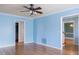 Open living room with hardwood floors, access to other rooms, and neutral paint at 1105 Edith St, Burlington, NC 27215