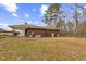 Large backyard with mature trees surrounding the home at 1113 W Mount Dr, Rocky Mount, NC 27803