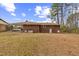 Large backyard with mature trees surrounding the home at 1113 W Mount Dr, Rocky Mount, NC 27803