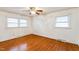 Simple bedroom with hardwood floors and two windows at 1113 W Mount Dr, Rocky Mount, NC 27803
