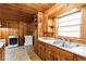 Kitchen with wood cabinets, sink, and laundry hookups at 1113 W Mount Dr, Rocky Mount, NC 27803