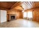 Living room with wood paneling, fireplace, and hardwood floors at 1113 W Mount Dr, Rocky Mount, NC 27803