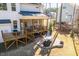 Backyard view featuring a patio, screened-in porch, and surrounding greenery at 1141 Barley Stone Way, Raleigh, NC 27603