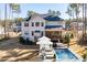 Backyard with pool, lounge chairs, patio, screened-in porch, and well-maintained lawn at 1141 Barley Stone Way, Raleigh, NC 27603