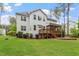 Exterior view showcasing a large backyard with a screened-in porch and brick patio at 1141 Barley Stone Way, Raleigh, NC 27603