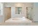 Luxurious primary bathroom with a soaking tub and tiled walk-in shower at 1141 Barley Stone Way, Raleigh, NC 27603
