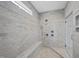 Walk-in shower with full marble surround and a modern shower head fixture at 1141 Barley Stone Way, Raleigh, NC 27603