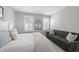 Serene bedroom with a plush sofa, two windows with shutters, and a comfortable bed at 1141 Barley Stone Way, Raleigh, NC 27603