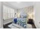 Comfortable bedroom featuring a patterned bedspread, elegant wallpaper, and natural light from the window at 1141 Barley Stone Way, Raleigh, NC 27603