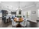 Charming dining area with a wooden table and chandelier, next to the kitchen at 1141 Barley Stone Way, Raleigh, NC 27603