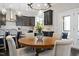 Stylish dining area features a round wooden table, chandelier, and wainscoting at 1141 Barley Stone Way, Raleigh, NC 27603