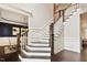Grand foyer featuring an elegant staircase with white wainscoting and dark wood floors at 1141 Barley Stone Way, Raleigh, NC 27603