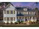 Two-story home boasts a brick facade, shutters, and a welcoming front porch at 1141 Barley Stone Way, Raleigh, NC 27603