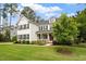 Beautiful white brick home with black shutters, a manicured lawn, and mature trees at 1141 Barley Stone Way, Raleigh, NC 27603