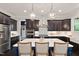 Beautiful kitchen with dark cabinets, a large island with seating, and stainless steel appliances at 1141 Barley Stone Way, Raleigh, NC 27603