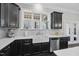 Bright kitchen boasts a farmhouse sink, marble backsplash, and stainless steel appliances at 1141 Barley Stone Way, Raleigh, NC 27603
