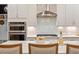 Close up of Kitchen island with double ovens and modern tile backsplash at 1141 Barley Stone Way, Raleigh, NC 27603