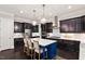 Well-equipped kitchen featuring dark wood cabinets and a blue island with white countertops at 1141 Barley Stone Way, Raleigh, NC 27603