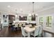 Spacious eat-in kitchen with dark cabinets, a large island, and modern lighting at 1141 Barley Stone Way, Raleigh, NC 27603