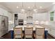 Gourmet kitchen featuring white cabinets, stainless appliances, and a large center island at 1141 Barley Stone Way, Raleigh, NC 27603