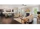 Open-concept living space with hardwood floors, a fireplace, and access to the kitchen at 1141 Barley Stone Way, Raleigh, NC 27603