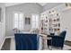 Bright living room with custom built-in bookshelves, plantation shutters, and contemporary furnishings at 1141 Barley Stone Way, Raleigh, NC 27603