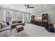 Large living room has floor to ceiling windows, a sectional sofa, and a TV at 1141 Barley Stone Way, Raleigh, NC 27603