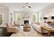 Bright living room with a fireplace, large windows, and neutral furniture at 1141 Barley Stone Way, Raleigh, NC 27603