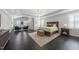 Expansive main bedroom with sitting area, tray ceiling, and hardwood floors at 1141 Barley Stone Way, Raleigh, NC 27603