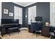 Dark-walled home office features two large windows, a piano and wood desk at 1141 Barley Stone Way, Raleigh, NC 27603