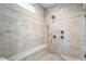 A tiled shower with built-in seating and dual shower heads at 1141 Barley Stone Way, Raleigh, NC 27603
