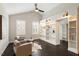 Comfortable sitting room with vaulted ceiling, built in shelves, dark floors, and bright natural light at 1141 Barley Stone Way, Raleigh, NC 27603