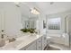 Bright bathroom featuring double sink vanity, separate shower, and soaking tub with glass block window at 11412 N Radner Way, Raleigh, NC 27613