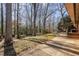 A home's backyard features mature trees providing shade and a patio that is perfect for outdoor entertaining at 1205 Glen Eden Dr, Raleigh, NC 27612