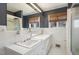 Clean bathroom with white tile, large sink, and shower, offering a bright and functional space at 1205 Glen Eden Dr, Raleigh, NC 27612