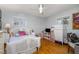 Bright bedroom featuring a white bed, hardwood floors, and windows offering ample natural light at 1205 Glen Eden Dr, Raleigh, NC 27612