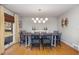 Elegant dining room with modern chandelier, stylish chairs, and hardwood floors for memorable meals at 1205 Glen Eden Dr, Raleigh, NC 27612