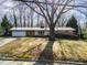 Brick ranch house with attached garage and mature tree at 1205 Glen Eden Dr, Raleigh, NC 27612