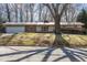 Charming single story home with a manicured front yard, mature shade tree, and attached garage at 1205 Glen Eden Dr, Raleigh, NC 27612
