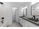 Bathroom with a double sink vanity, black fixtures and a tiled floor. Bathtub and shower in the background at 125 Sue-Kim Dr, Youngsville, NC 27596