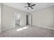 Bedroom with neutral walls, a ceiling fan, carpet and a view to the en-suite bathroom at 125 Sue-Kim Dr, Youngsville, NC 27596