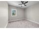 Carpeted bedroom with a ceiling fan, neutral paint and a window with natural light at 125 Sue-Kim Dr, Youngsville, NC 27596