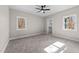 Bedroom with neutral walls, carpet, a ceiling fan and windows with natural light at 125 Sue-Kim Dr, Youngsville, NC 27596